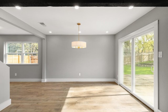 unfurnished dining area with wood-type flooring