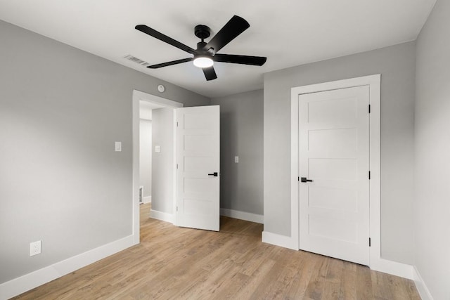 unfurnished bedroom featuring light wood-type flooring and ceiling fan