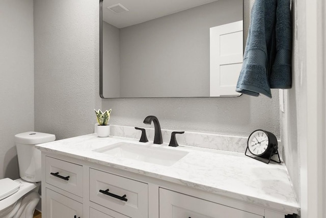 bathroom with vanity and toilet