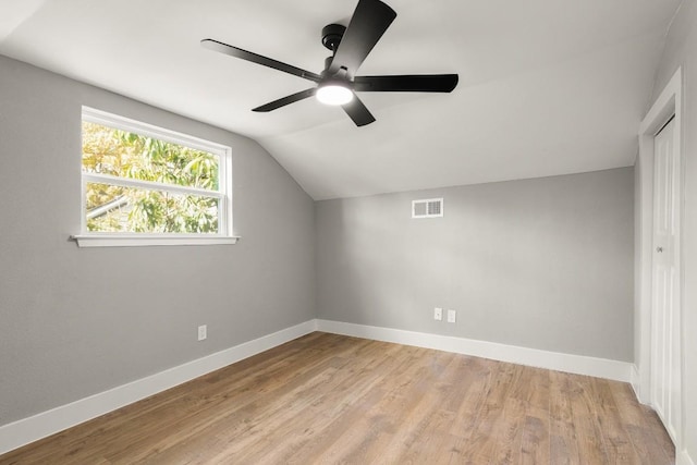 additional living space with ceiling fan, light hardwood / wood-style floors, and vaulted ceiling