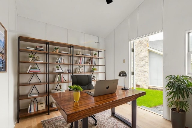 office space featuring light hardwood / wood-style floors and vaulted ceiling