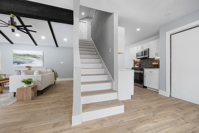 staircase featuring lofted ceiling with beams, baseboards, wood finished floors, and recessed lighting