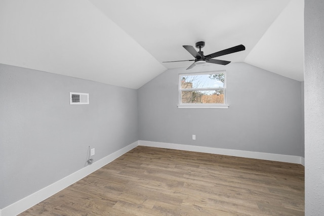 bonus room with visible vents, vaulted ceiling, light wood-style flooring, and baseboards