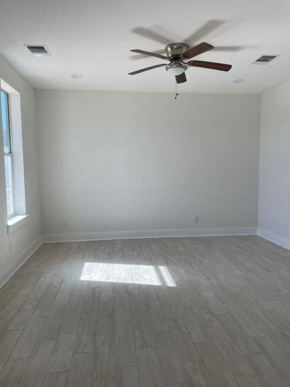 empty room with wood-type flooring and ceiling fan