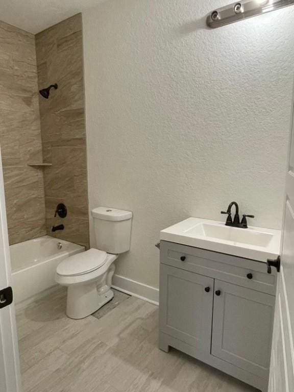 full bathroom with vanity, toilet, and tiled shower / bath combo