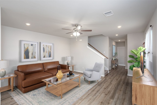 living room with ceiling fan and hardwood / wood-style flooring