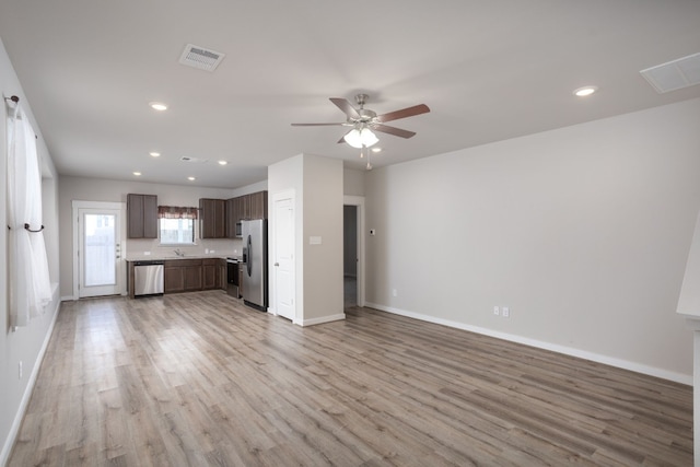 kitchen featuring sink, light hardwood / wood-style flooring, ceiling fan, dark brown cabinetry, and stainless steel appliances