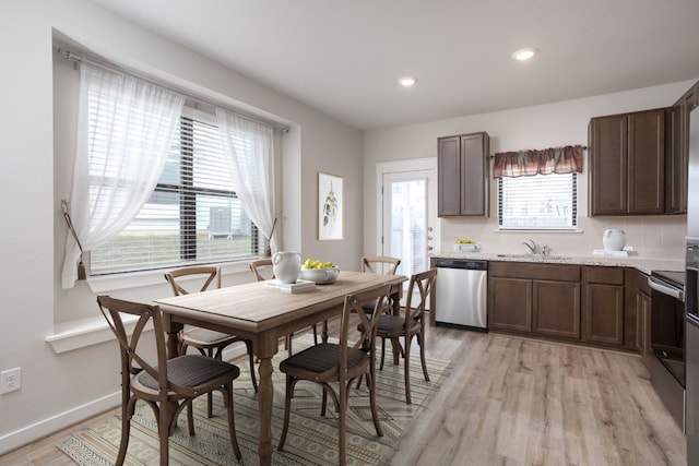 dining room with light wood-type flooring and sink