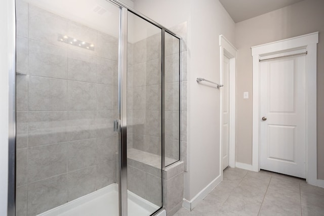 bathroom featuring tile patterned flooring and a shower with shower door