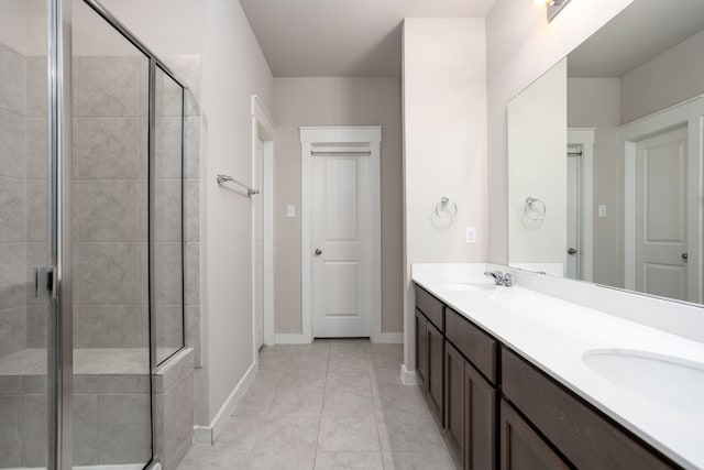 bathroom featuring vanity, tile patterned floors, and a shower with shower door