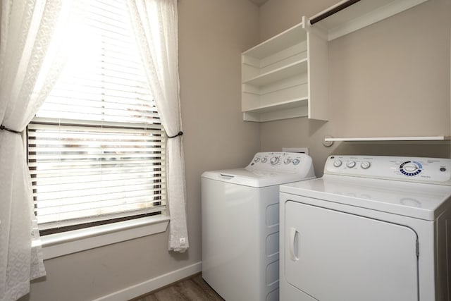 clothes washing area with separate washer and dryer and dark hardwood / wood-style flooring