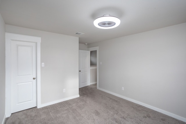 unfurnished bedroom featuring light colored carpet