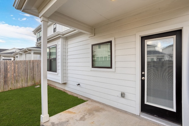 view of exterior entry featuring a yard