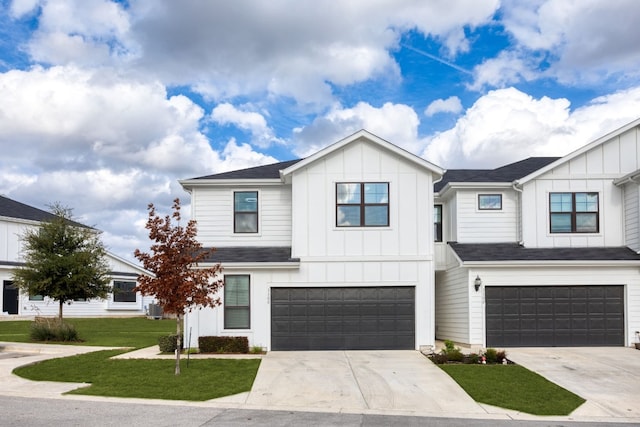 view of front of property featuring a garage and a front lawn