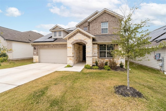 view of front of house with solar panels, a garage, and a front lawn