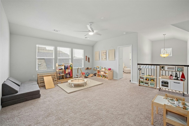 recreation room with carpet floors, vaulted ceiling, and ceiling fan