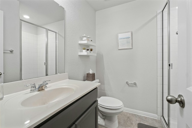 bathroom featuring tile patterned floors, vanity, toilet, and an enclosed shower