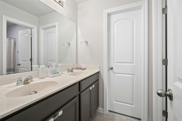 bathroom with tile patterned floors and vanity