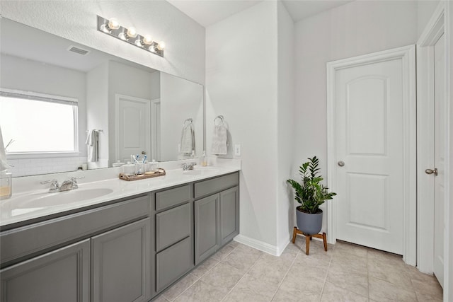 bathroom with tile patterned flooring and vanity