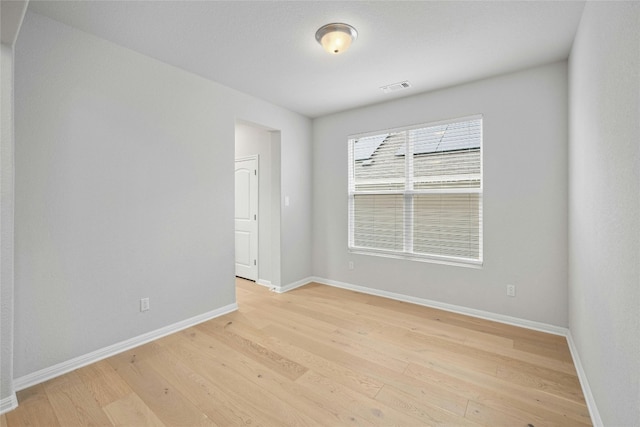 unfurnished room with light wood-type flooring