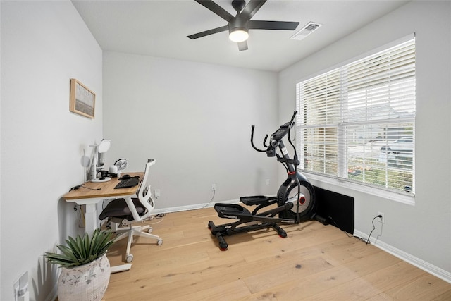 workout area with ceiling fan and wood-type flooring