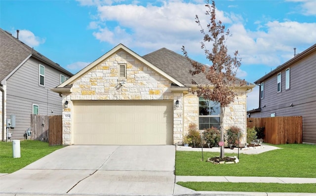 view of front of home with a garage and a front lawn