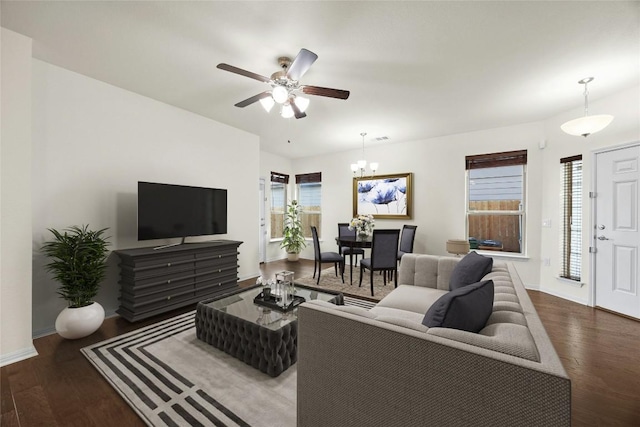 living room with hardwood / wood-style floors and ceiling fan with notable chandelier