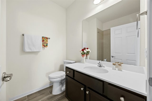 bathroom with vanity, toilet, and a shower