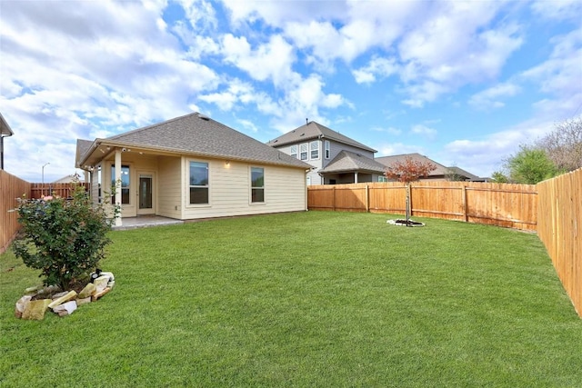 back of property with a lawn and a patio