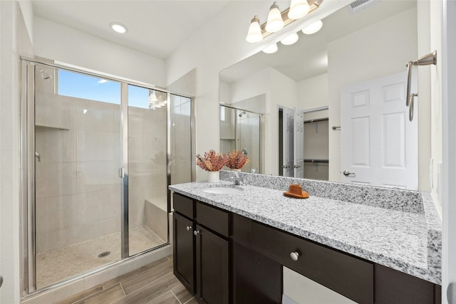 bathroom featuring vanity and an enclosed shower