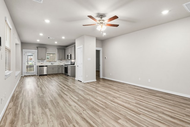 unfurnished living room featuring light hardwood / wood-style floors and ceiling fan