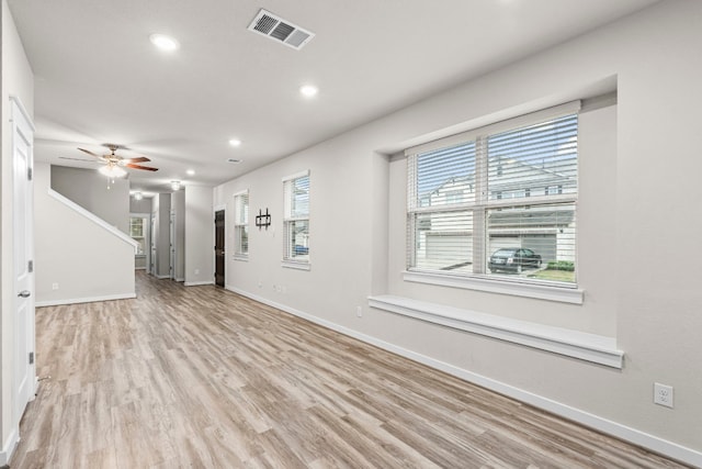 unfurnished living room with ceiling fan and light hardwood / wood-style flooring