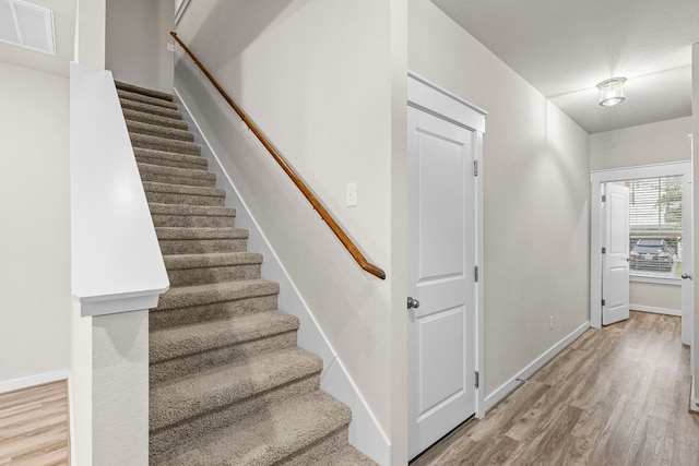 stairway featuring hardwood / wood-style floors