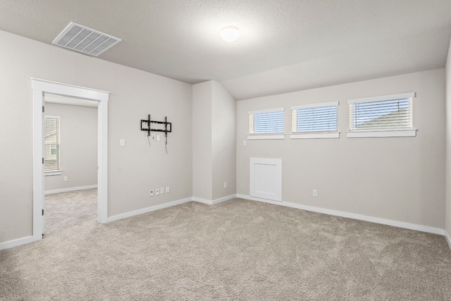 carpeted spare room featuring a textured ceiling