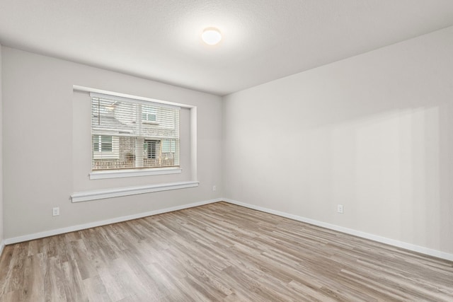 unfurnished room with light hardwood / wood-style floors