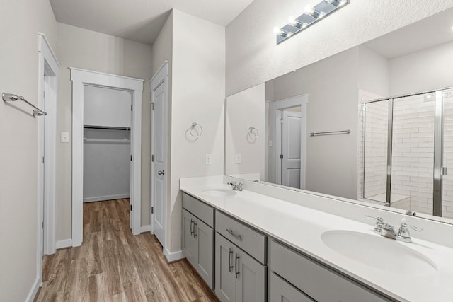 bathroom featuring vanity, hardwood / wood-style flooring, and walk in shower