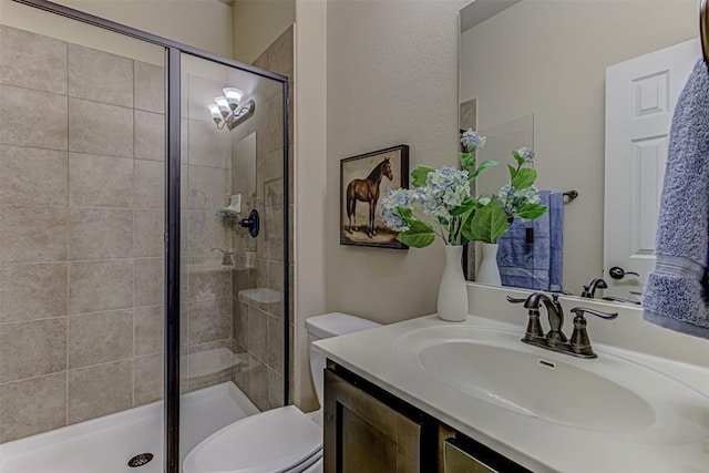 bathroom with vanity, an enclosed shower, and toilet