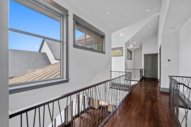 hall with dark hardwood / wood-style flooring and lofted ceiling