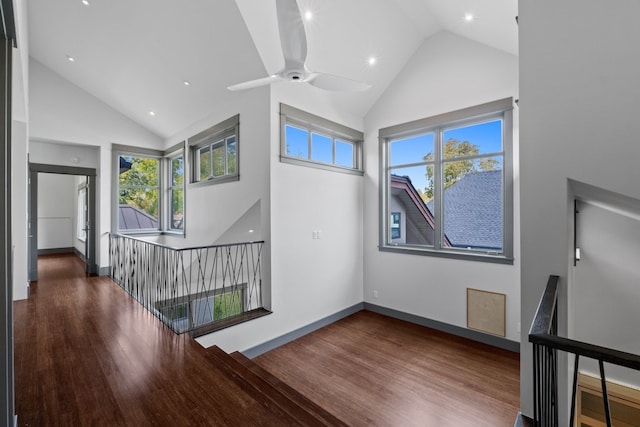 interior space with high vaulted ceiling, ceiling fan, and dark wood-type flooring