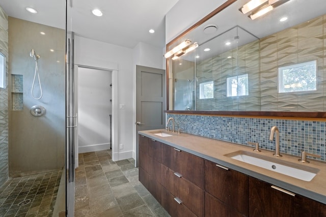 bathroom featuring decorative backsplash, an enclosed shower, and vanity