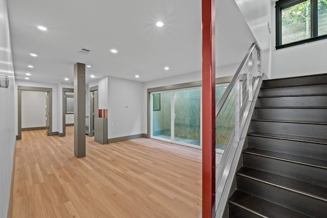 staircase with hardwood / wood-style floors