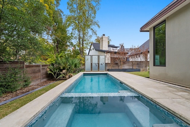 view of swimming pool featuring an in ground hot tub