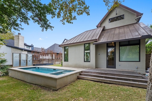 rear view of house featuring a fenced in pool