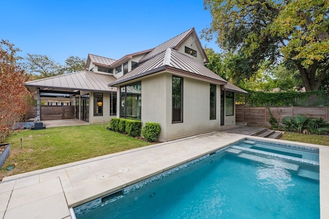 back of property with a lawn, a patio area, a fenced in pool, and a gazebo