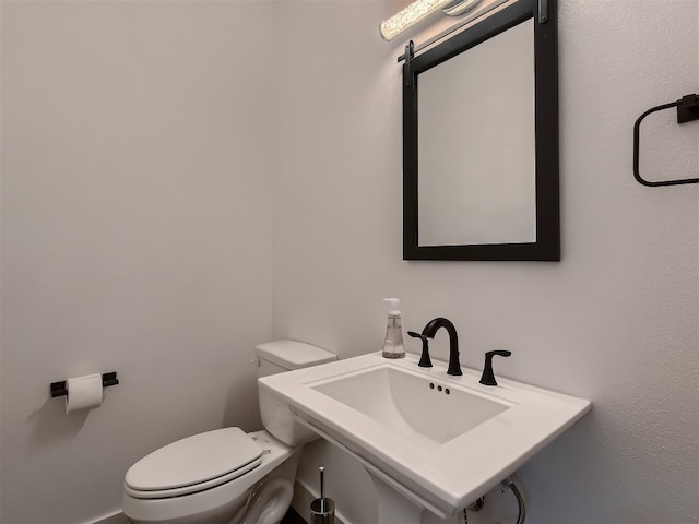 bathroom with toilet and sink