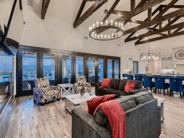 living room featuring beam ceiling, light wood-type flooring, high vaulted ceiling, and french doors