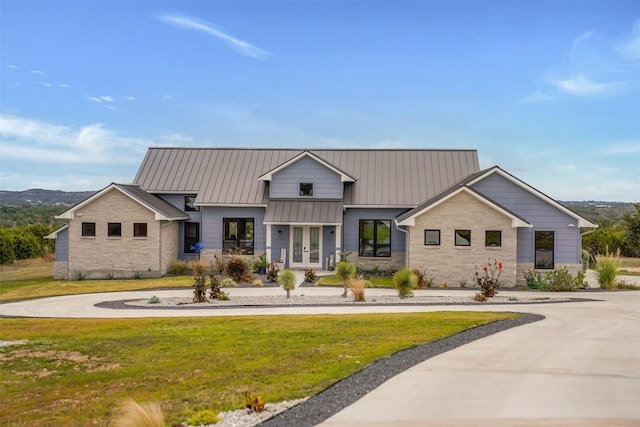 view of front of house with a front yard and french doors