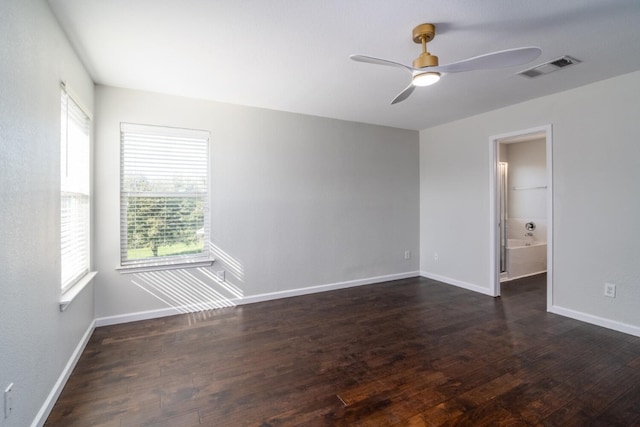 unfurnished room with dark hardwood / wood-style flooring and ceiling fan