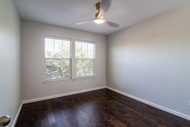 spare room with ceiling fan and dark hardwood / wood-style floors