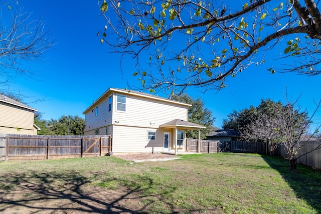 rear view of property with a yard and a patio